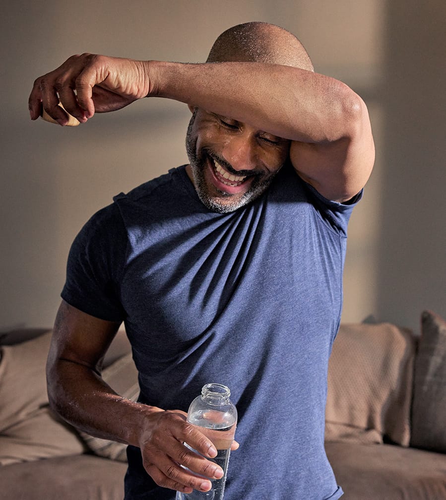 Man wiping sweat from brow